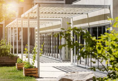 Canopy Awning on Entrance Building. Aluminum Pergola Garden by Modern House with Glass Facade Windows.  clipart