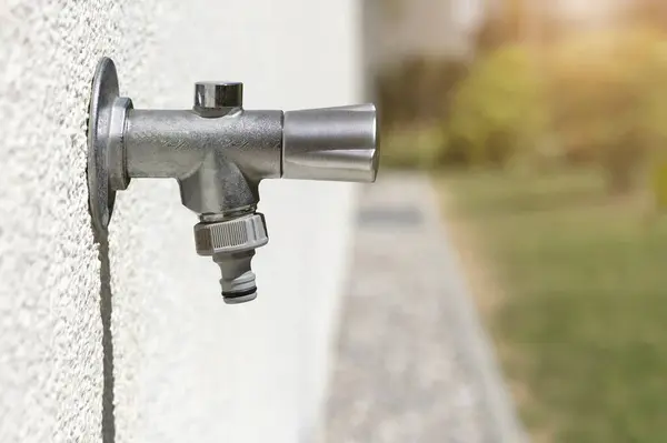 stock image Tap Outside on Wall. Modern Garden Tap Outdoors for Watering Garden. Water Faucet with Hosepipe Attachment. 