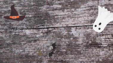 Ahşap doku ekranında Cadılar Bayramı elementleri tasarımı olan hareketli grafikler