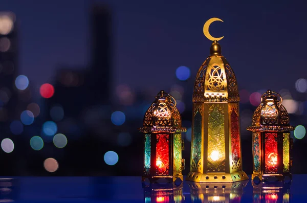 ラマダーン カレームの聖なる月のイスラム教徒の饗宴のための夜空と都市のボケ光の背景を持つ大きなランタンに焦点を当てます — ストック写真