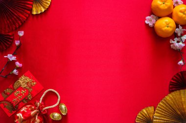 Kırmızı zarf paketleri veya ang bao (kelime ortalaması kılavuz), kırmızı çanta, külçe (kelime anlamı zenginlik) ve kırmızı bez arka planda portakallar olan Çin yeni yıl kavramı.