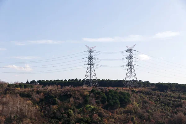 A couple of lattice pylons on a high voltage electricity network in a rural area.