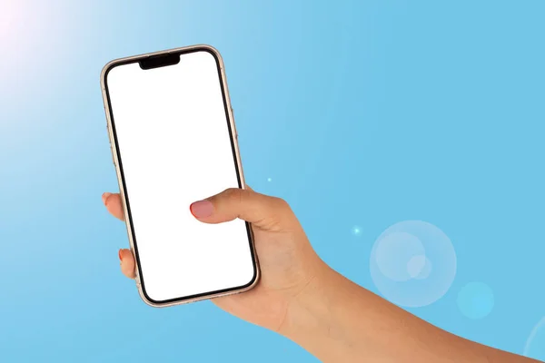 white woman hand with a white screen cell phone on blue background