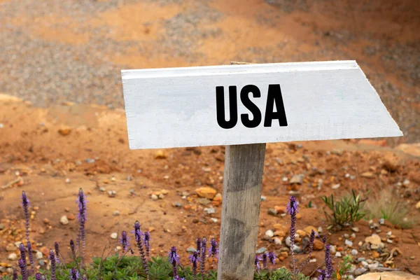 White wooden signpost with the word usa in a glowing light