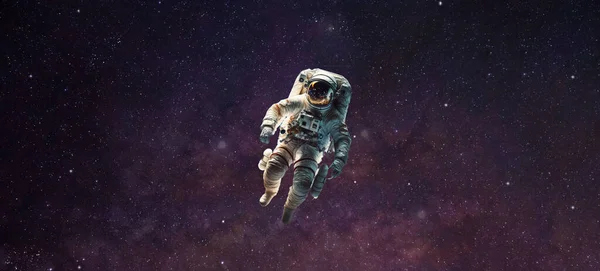astronaut floating in space in starry universe