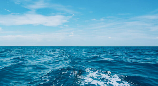 beautiful long sea with small waves and a blue sky