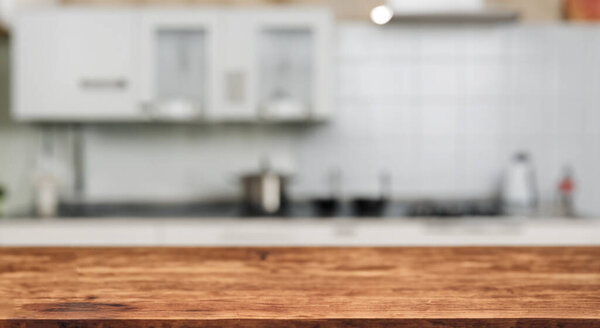 beautiful defocused kitchen with a new bar wood table