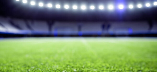 beautiful soccer field grass with defocused background with lights