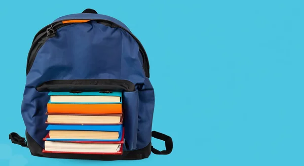 books on a black school bag on a blue background HD