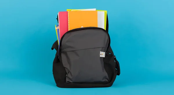 books on a school bag on a blue background HD