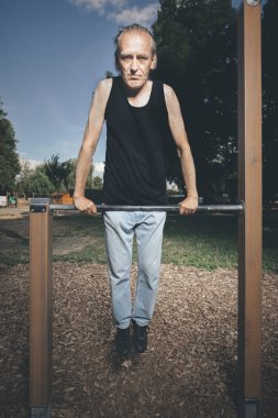 Kötü durumdaki çirkin adam dışarıda spor yapmaya çalışıyor.