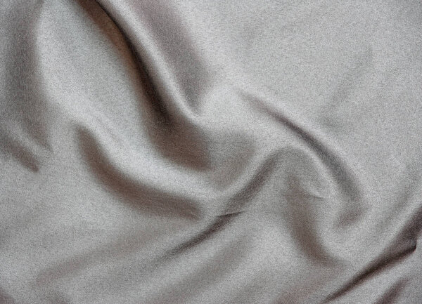 Smooth elegant black silk fabric or satin luxury cloth texture for abstract backgroun