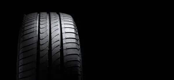 stock image Vehicle tire ot tyre profile on black background with copy space