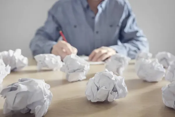 stock image Frustration stress and writers block, business man with crumpled paper balls in a pile