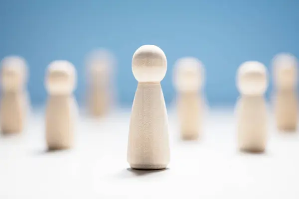 stock image Wooden business team with one person standing out from the crowd concept for leadership or individuality