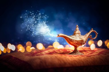 Magic lamp from the story of Aladdin with Genie appearing in blue smoke concept for wishing, luck and magic clipart