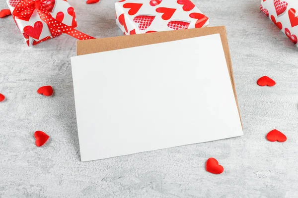 Blank wedding invitation stationery card mockup with envelope and red hearts and gifts on light grey background. Valentines day card, valentines day background, Mothers day card