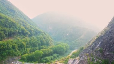 İnsansız hava aracının ApuAlps dağlarının manzarasına yavaşça inişi ve terk edilmiş mermer ocağı, Carrara, İtalya. Yaban kayaları ve endüstriyel atıklar, yağmurdan sonra parlak güneş ışığı. Güneşli bir gün