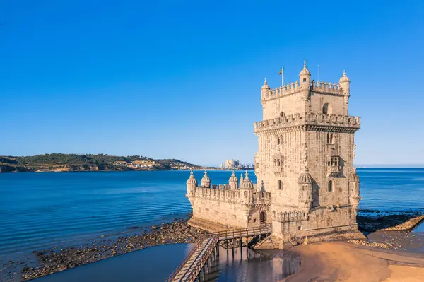 stock image Famous landmark of Belem tower, Lisbon, Portugal at blue summer day sky. Medieval fortification on Tagus river in late Gothic or Manueline style, UNESCO world heritage site, Age of Discoveries