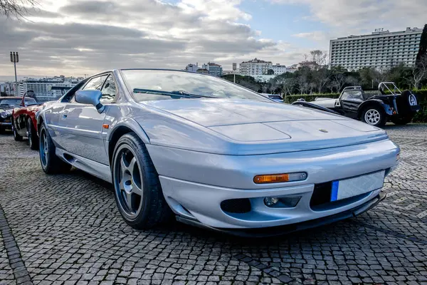 stock image Lisbon, Portugal - Jan 20, 2024: Classic silver two-seater coupe of Lotus Esprit Sport 350 sports car parked on cobblestone pavement road. 