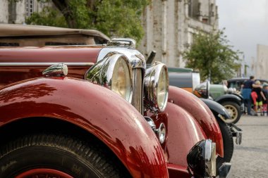 Lisbon, Portugal - Oct 15, 2023: Close-up of side view headlight and front fender of vintage red Lagonda LG45 in selective focus. Luxury sports car of 1930s, 2-door drophead coupe version, Lagonda, UK clipart