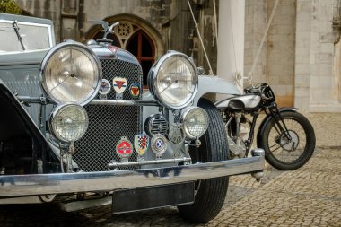 Lisbon, Portugal - Oct 15, 2023: Front view of Alvis Speed 20 drophead coupe parked in driveway near historic building. Mid-size 2-door touring class car, 1930s, by Alvis Car and Engineering Company clipart