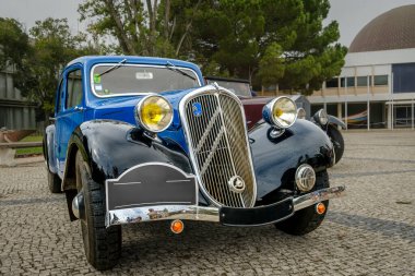 Lisbon, Portugal - Oct 15, 2023: Famous classic Citroen Traction Avant known as 7c parked on cobblestone driveway. First mass-produced monocoque-bodied and front-wheel drive car in the world clipart