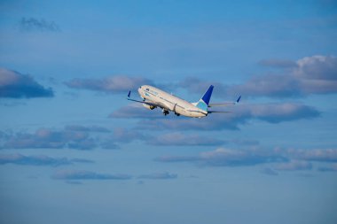 Lizbon, Portekiz - 29 Nisan 2024: ASL Airlines Boeing 737, güneşli bir günde havalandıktan sonra bulutlarla birlikte açık mavi gökyüzüne yükseldi. Hava trafiği, tatiller, seyahatler, varış yerleri