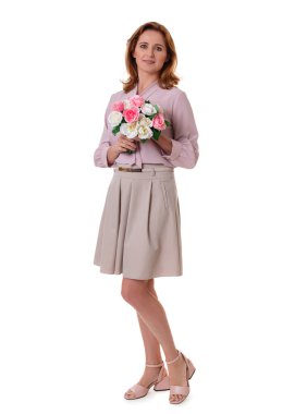 Full size portrait of an attractive elegant young woman holding bouquet isolated over white background.