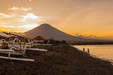 Breathtaking sunset view on Agung volcano from Amed beach in Bali, Indonesia clipart
