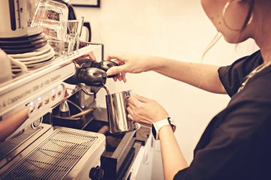 Barista preparing coffee at coffee machine. Coffee shop counter