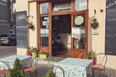 Street cafe decorated with flowers in the historical center of Krakow, Main Market Square, Poland