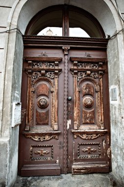 Old wooden carved door in the historical center of Krakow, Poland