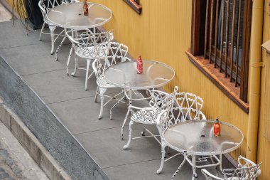 White cafe furniture along the yellow wall creative cafe exterior