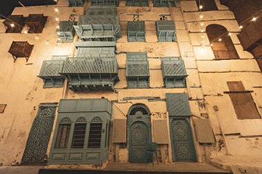 Eski Jeddad kasabasındaki tarihi ev. Akşam ışıkları için ahşap pencereler ve kapılar. Suudi Arabistan.