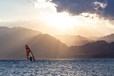 Wind-surfer on the water in Lagoon Dahab area at sunset, Sinai, Egypt