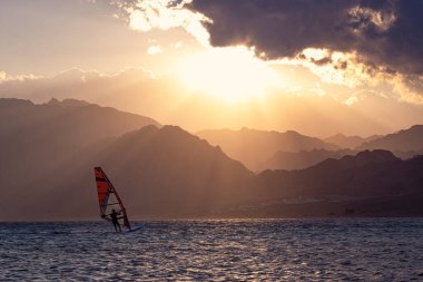 Wind-surfer on the water in Lagoon Dahab area at sunset, Sinai, Egypt