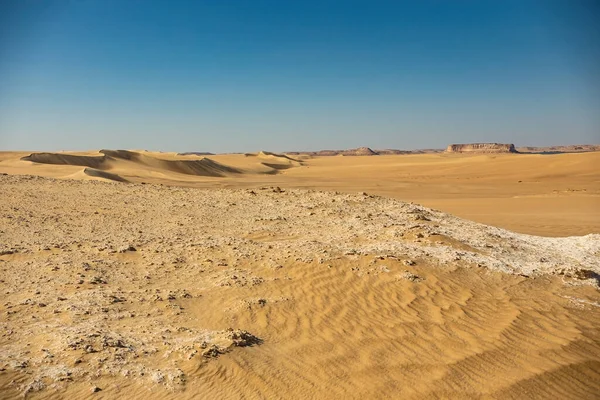 Desert landscape in Egypt. White desert in Egypt (Farafra). White stones and yellow sands.