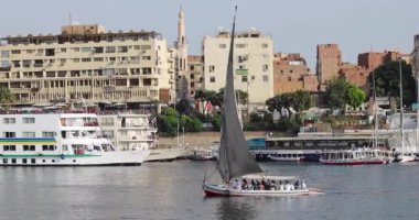 Günbatımında Nil 'de geleneksel felucca yelkenlisi, Aswan, Mısır