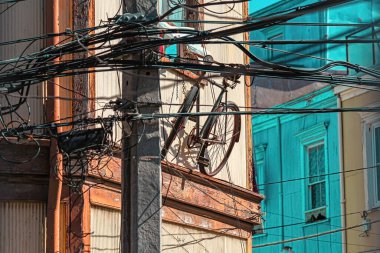 Valparaiso cityscape, colorful houses in Valparaiso, Chile. Old house with a spire against blue sky