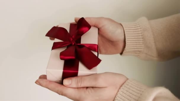 Woman Hands Holding Gift Close Soft Pink Colors Red Ribbon — Stock Video