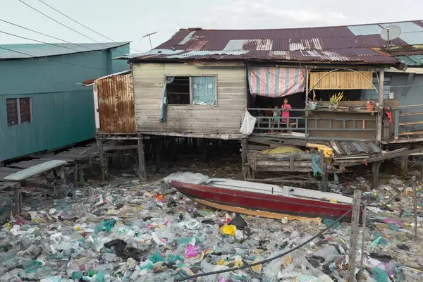 stock image Fishing village houses over the water garbage poor areas in Sabah province in Malaysia