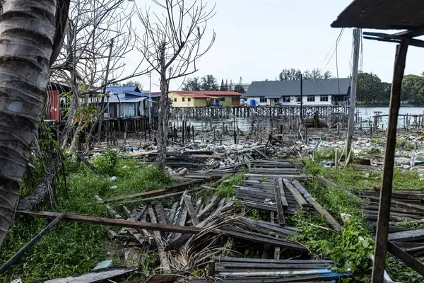 stock image Fishing village houses over the water garbage poor areas in Sabah province in Malaysia