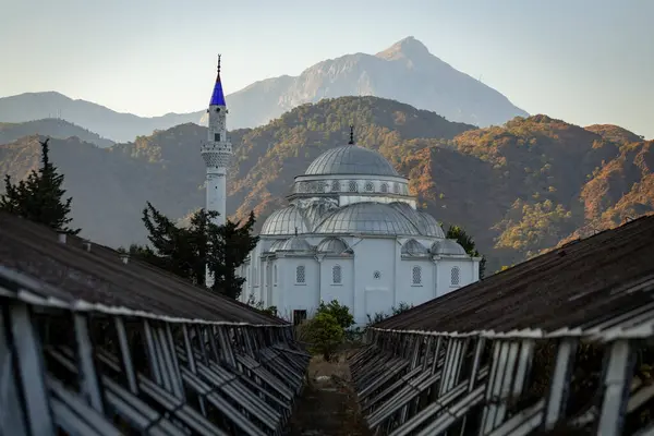 stock image Cirali mosque with mountains on background and green houses around Cirali Antalia Turkey