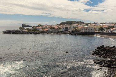 Traditional houses on the cliff at Atlantic ocean coast in Sao Miguel Azores islands Portugal clipart