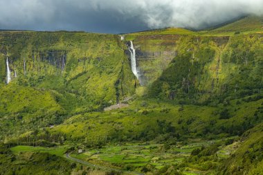 Breathtaking view of waterfall in the green mountains on Flores island Azores Portugal clipart