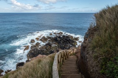 Breathtaking view of the wavy Atlantic ocean from the cliff in Azores islands Portugal clipart