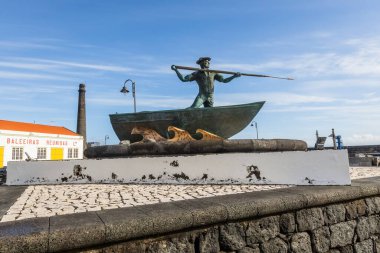 Whaleman monument in the harbor of Pico island Azores Purtugal clipart