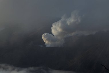 Smoke rising from Bromo volcano, Mount Bromo eruption Java island Indonesia clipart