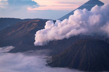 Smoke rising from Bromo volcano, Mount Bromo eruption Java island Indonesia clipart